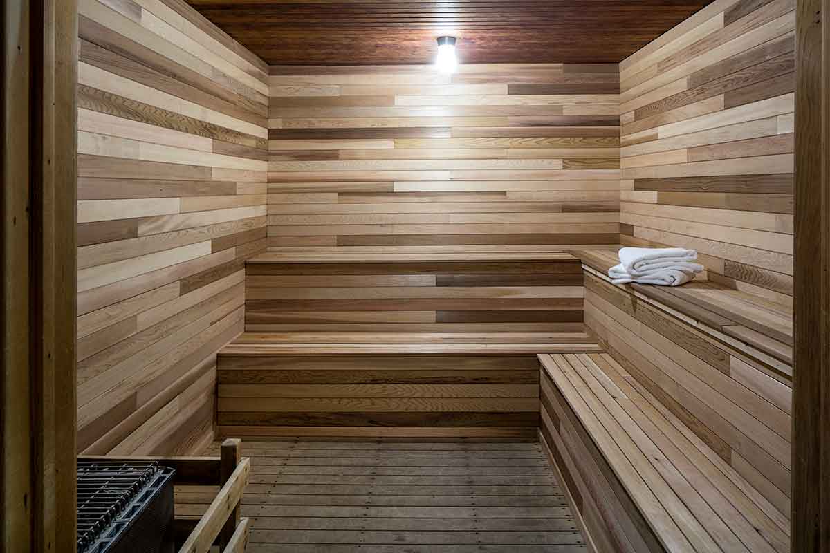 A wooden sauna with towels and a light