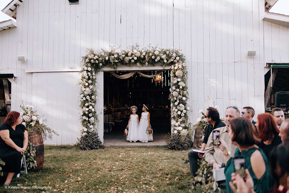 Flower Girls Walk Down Aisle at Nebraska Wedding Venue
