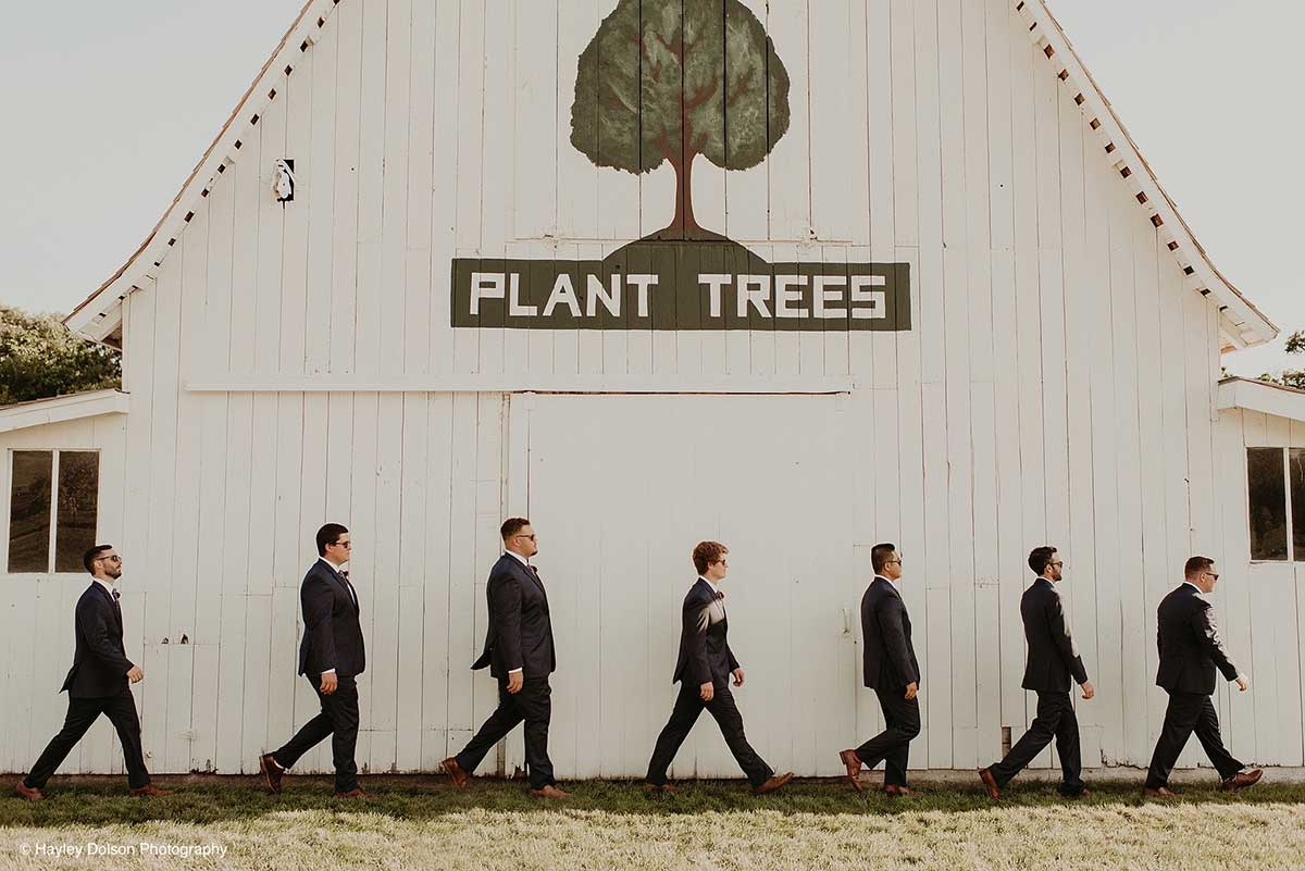A Bridal Party Poses Outside the Historic Barns