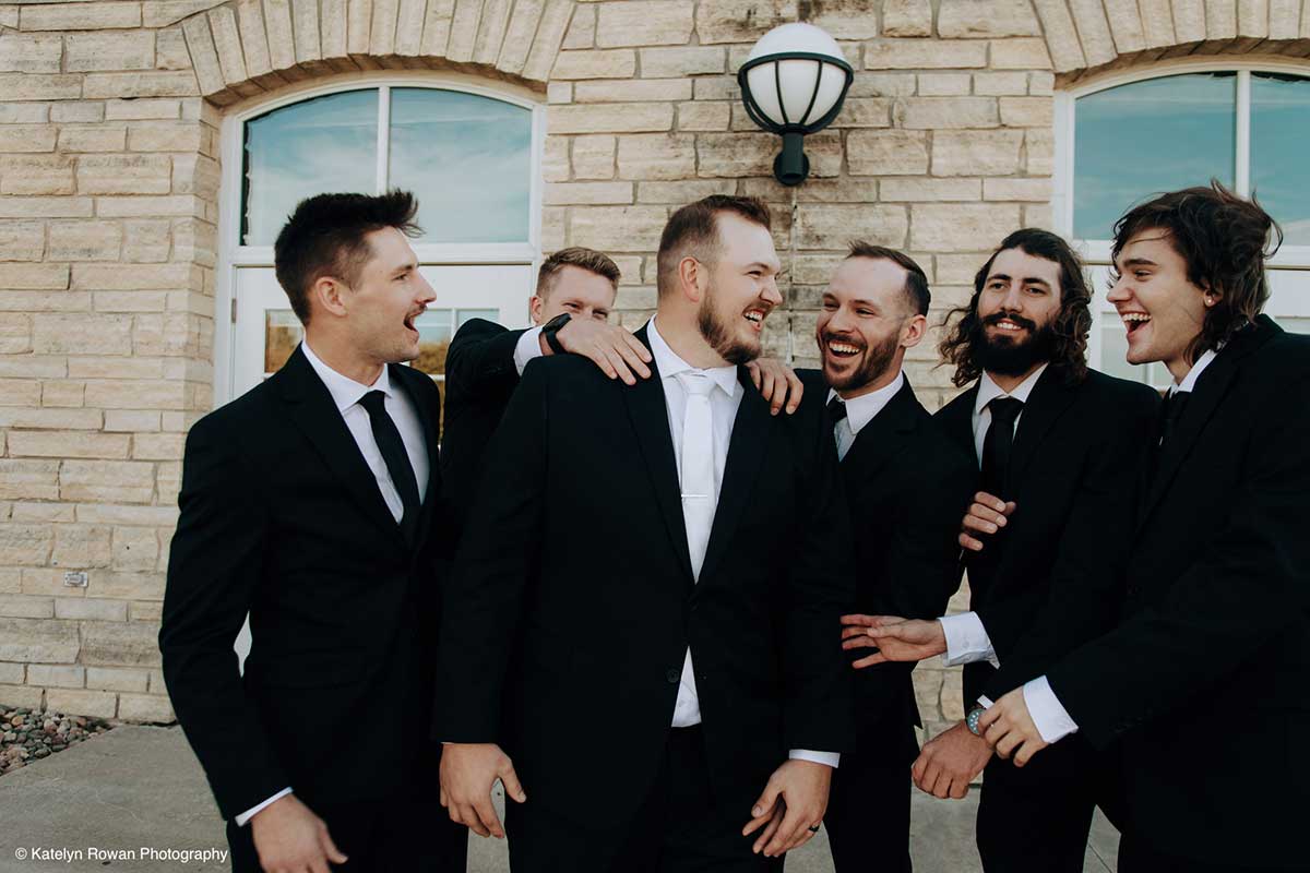 A Groom and His Groomsmen Smile and Laugh