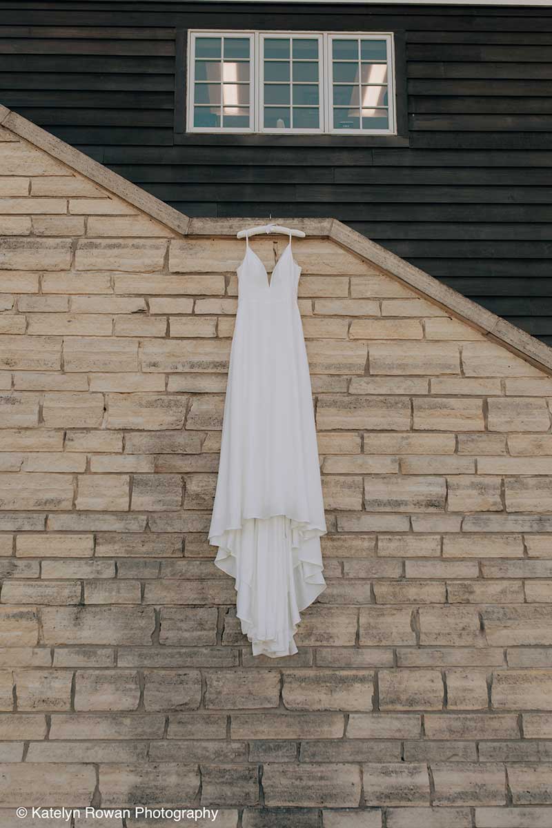 A Wedding Dress Hangs off the Edge of the Stairs