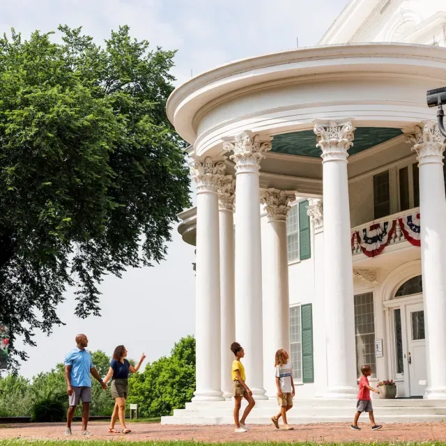 A family walking past a building outdoors