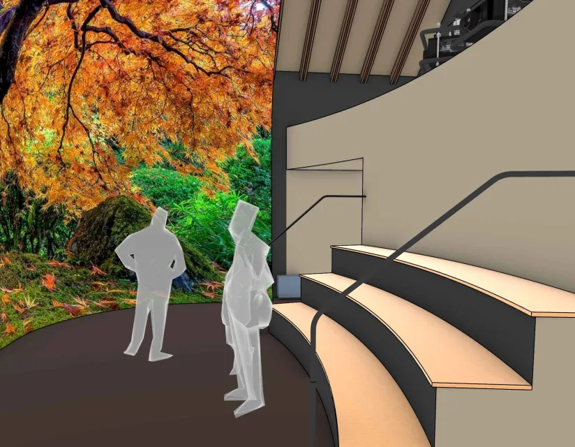 People viewing a large, vibrant autumn tree display in an indoor space with tiered seating and handrails.