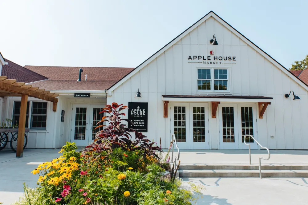 Apple House Market building featuring a charming exterior with inviting outdoor seating.