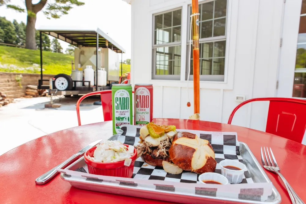A tray filled with various foods placed outdoors on a vibrant red table.