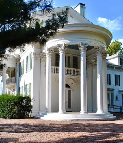 Arbor Lodge Mansion featuring tall columns and a spacious porch, showcasing classic architectural design.