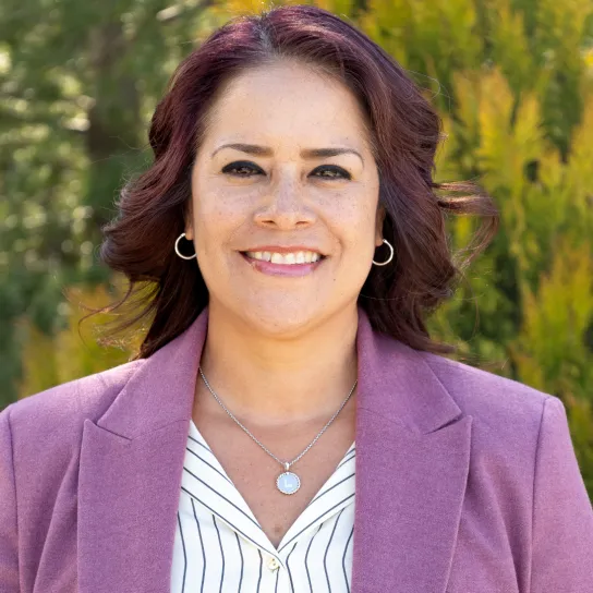 Headshot of a female employee who is standing outside.