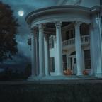 A grand white mansion at night, framed by large columns, with glowing jack-o'-lanterns on the steps and a full moon in a cloudy sky.