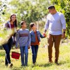 A family walking in an apple orchard